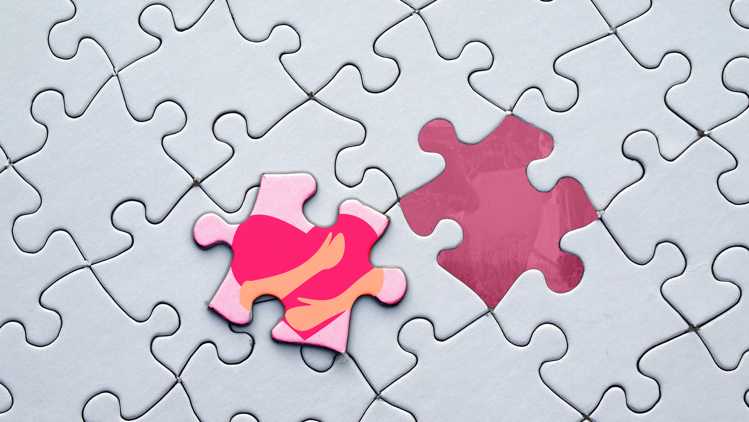 A puzzle with one missing piece. The remaining piece is pink with a red heart and two hands.