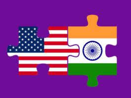 The American flag and the Indian flag are connected like two puzzle pieces, on a deep purple background.